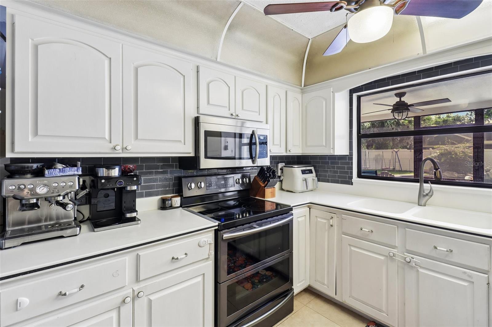 Stainless steel appliances, tiled backsplash. Stainless steel appliances, tiled backsplash.