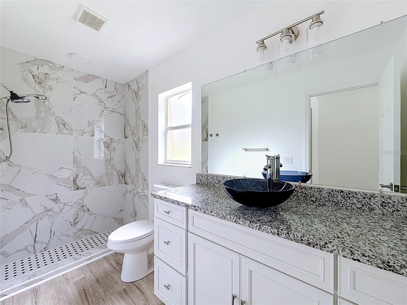 A tiled walk-in shower adds style to your daily routine.