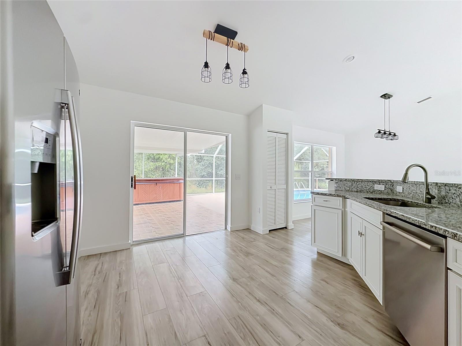 Sliding doors connect the kitchen to poolside living.