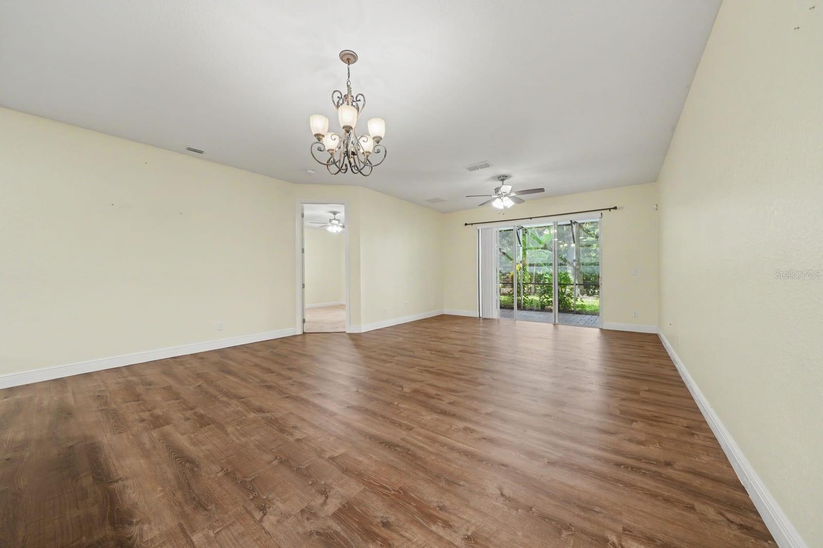 Spacious Living Room With Wood Flooring And Sliding Glass Patio Doors