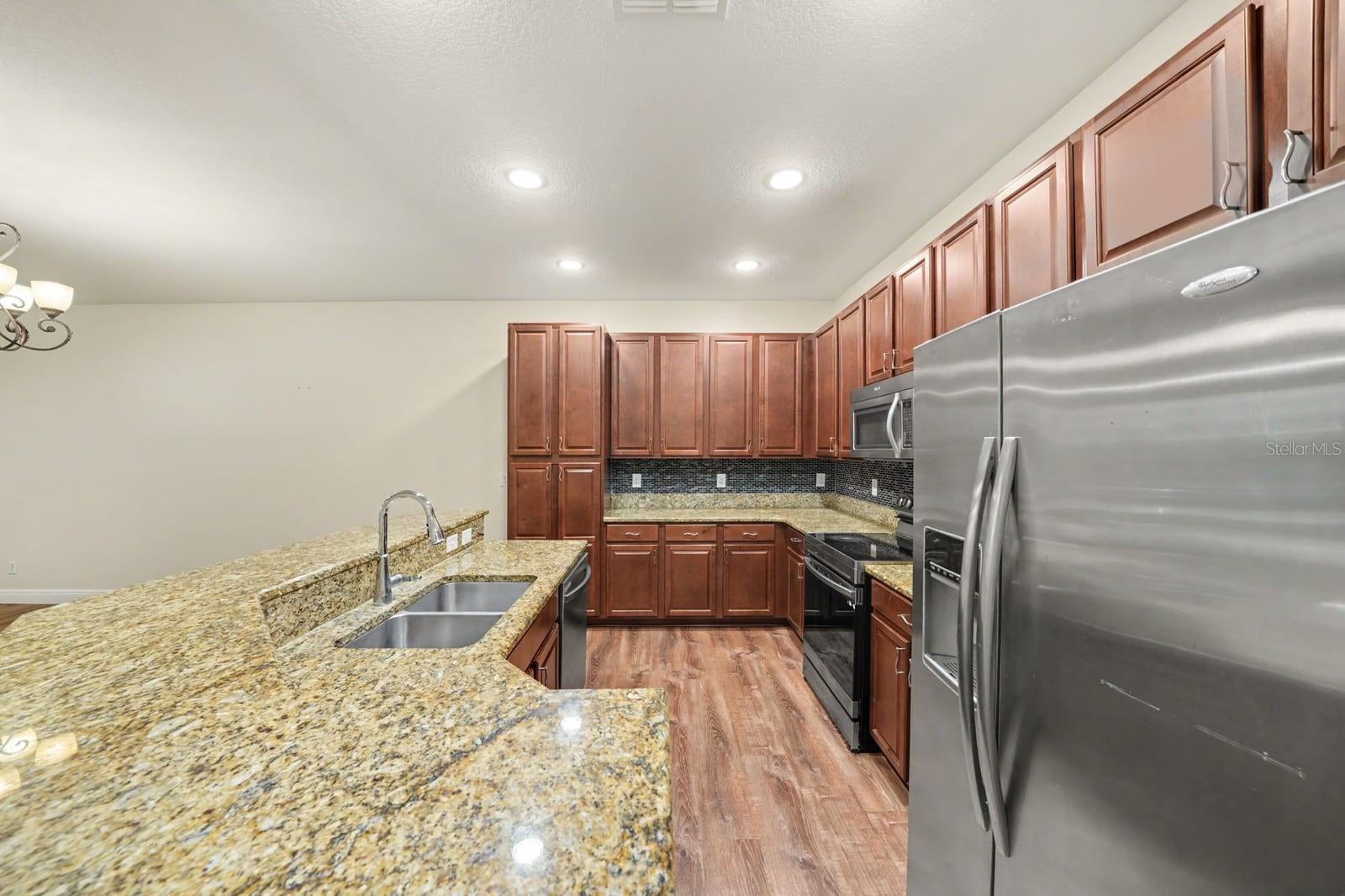Gourmet Kitchen With Granite Counters, Island Seating & Stainless Appliances