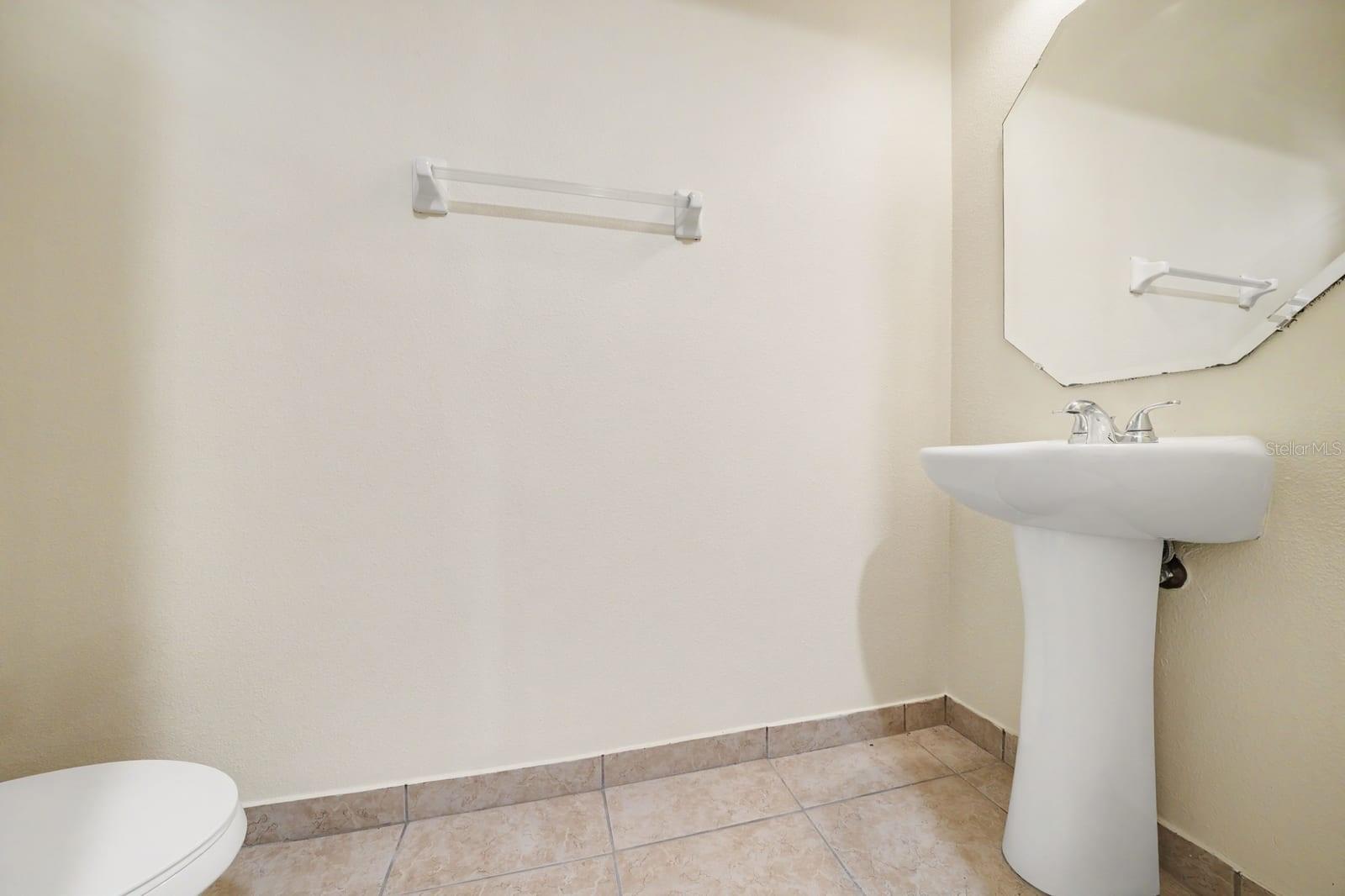 Half Bath with Pedestal Sink and Tile Flooring