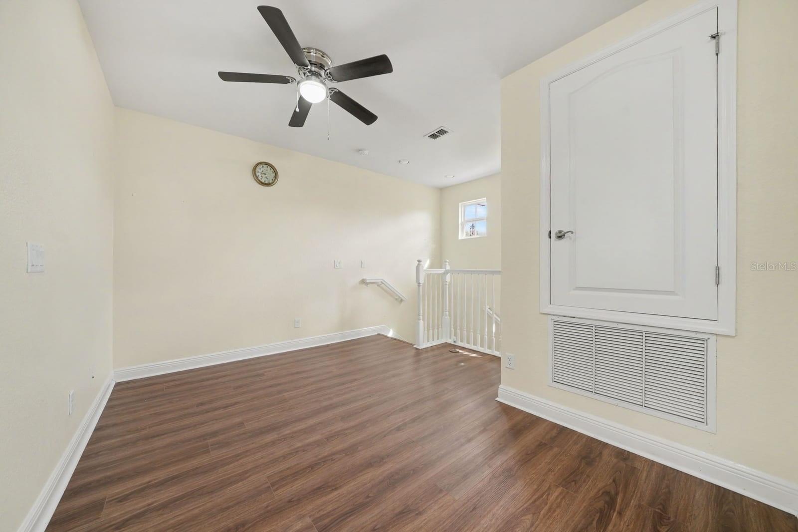 Bedroom with Vaulted Ceiling and Built-In Storage Shelves