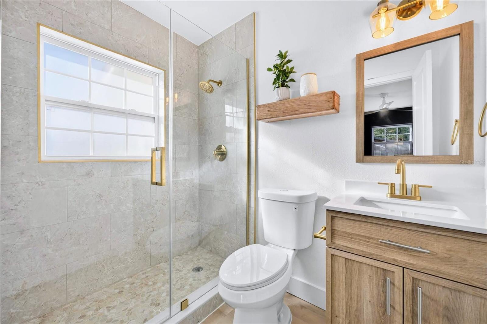 Primary Bathroom with updated tile and vanity for the new owners,