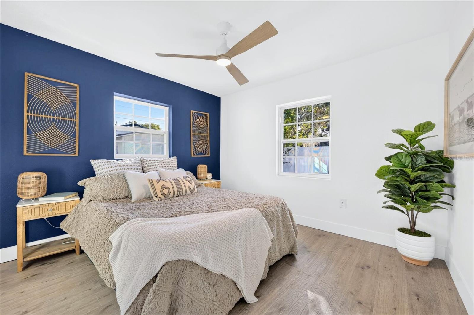 Finally the Primary bedroom with the splash of color on the wall that acts as a color headboard for the bedroom