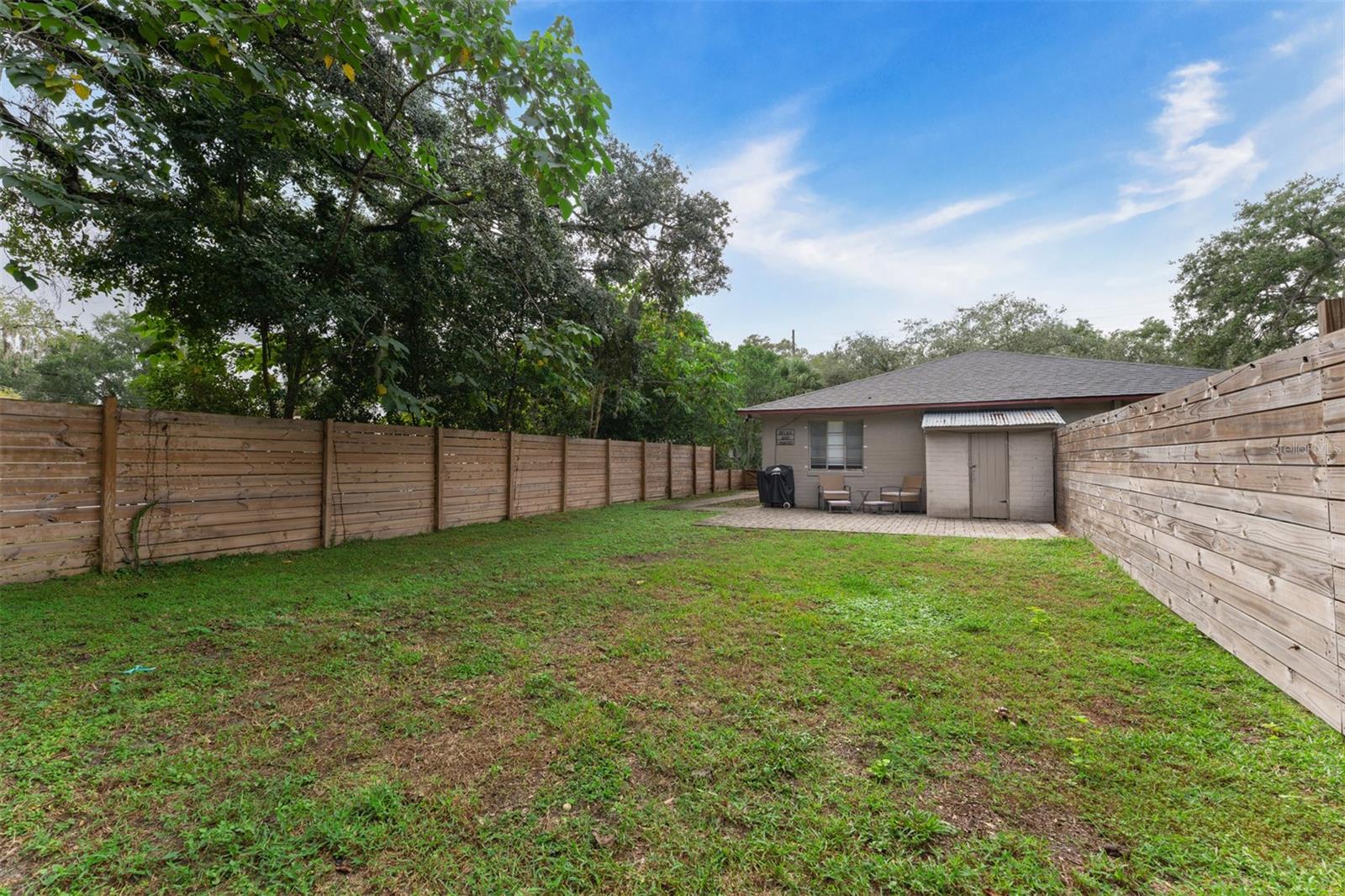 Fenced back yard with patio & outside storage