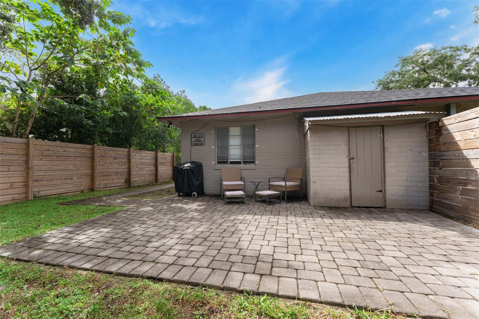 Fenced back yard with patio & outside storage