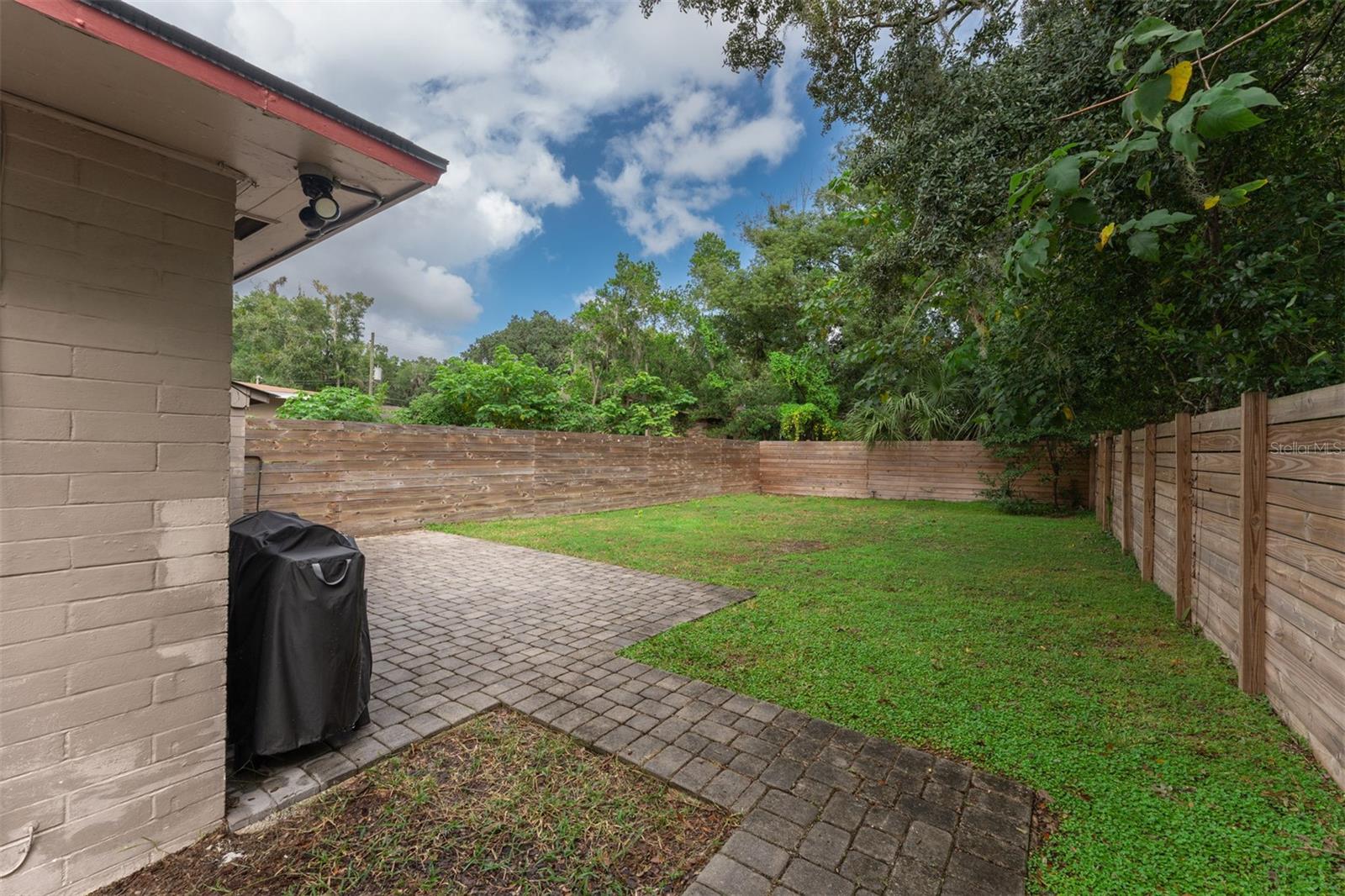 Fenced back yard with patio