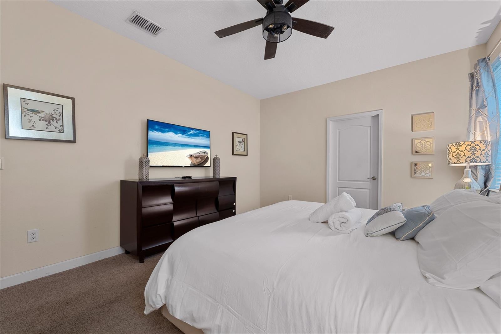 First-Floor Primary Suite with King Bed, Ceiling Fan and Flat-Screen Television