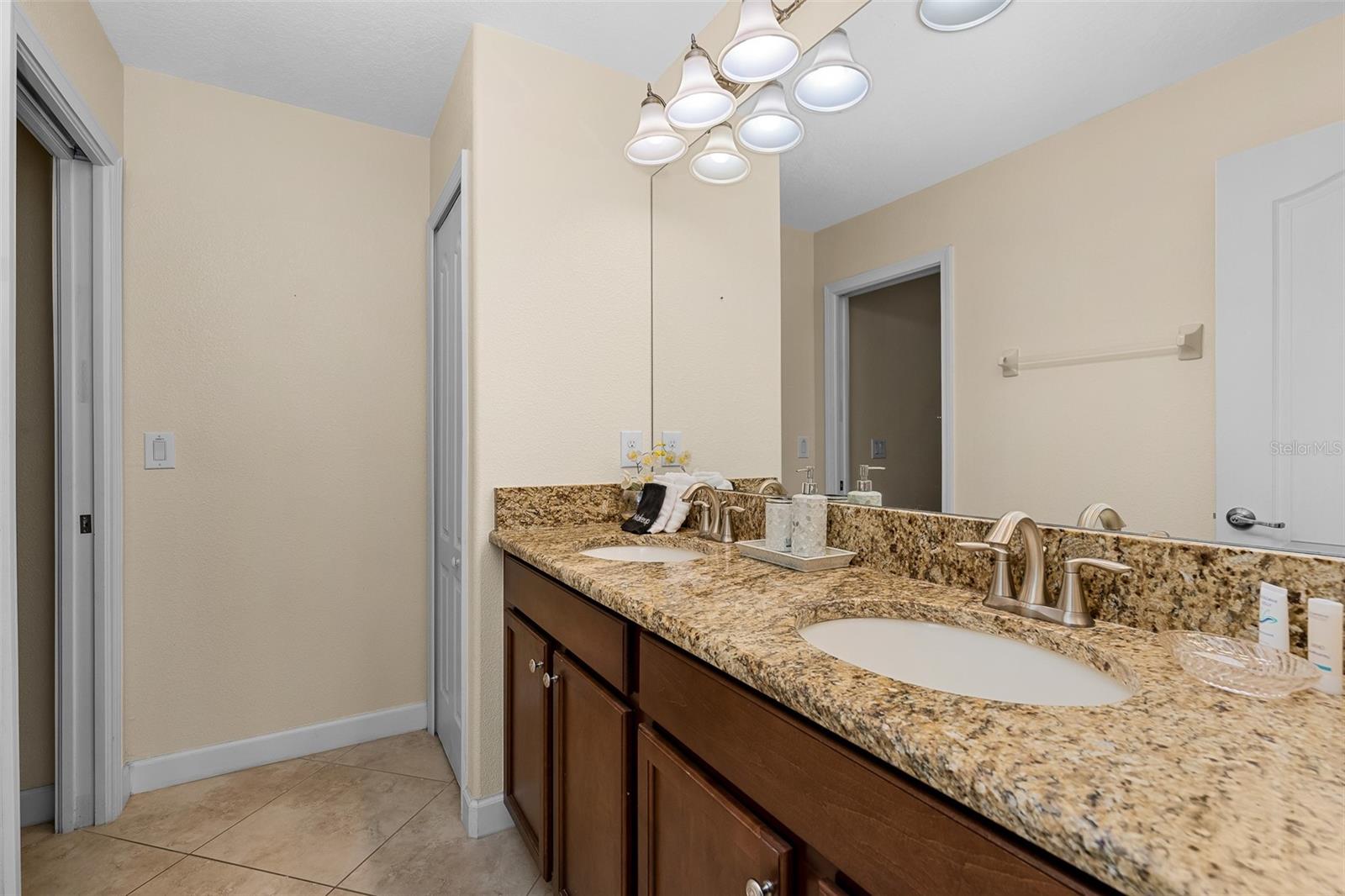 Guest Bathroom Featuring Granite Countertops, Double Vanity and Generous Counter Space