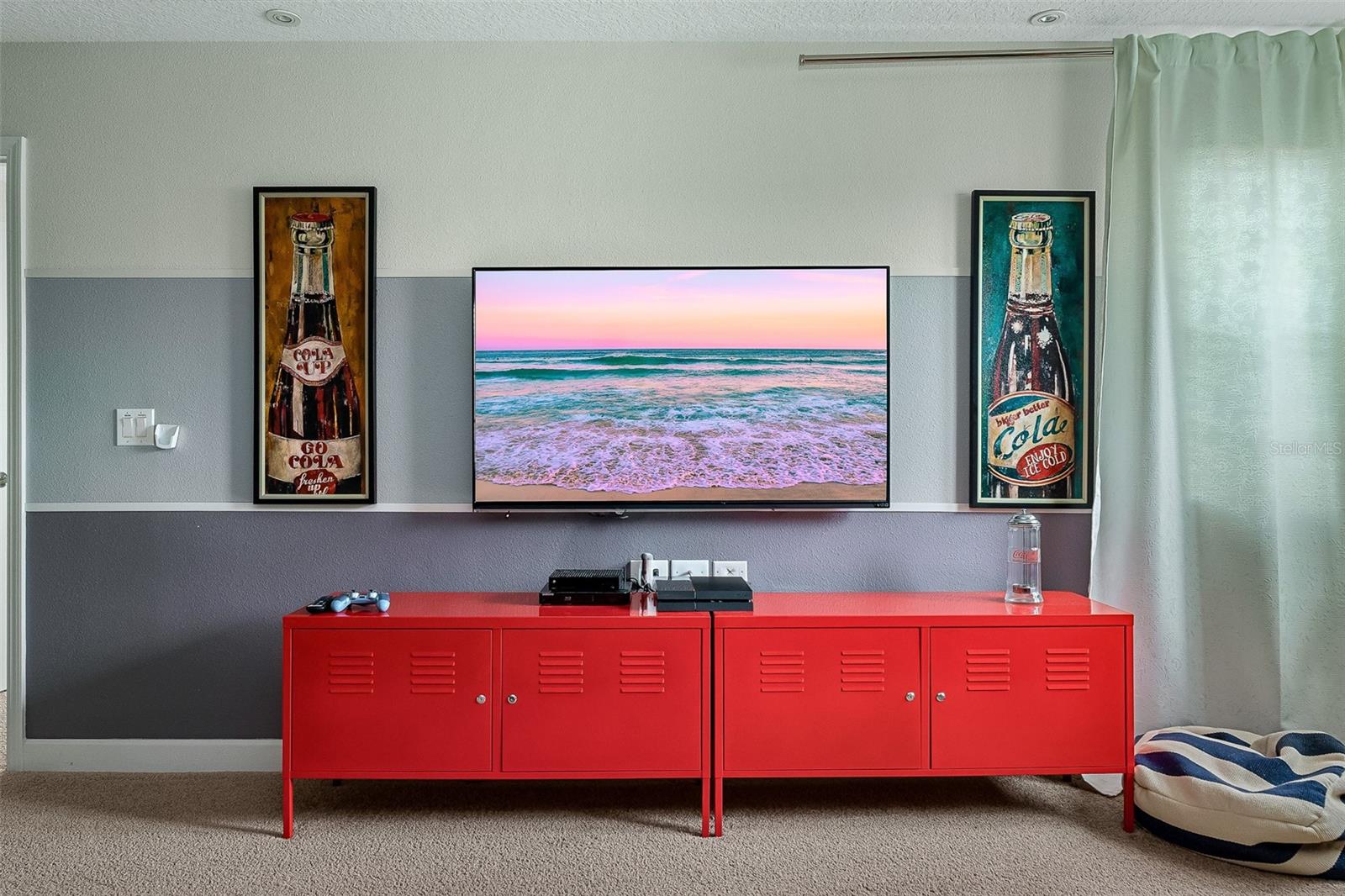 Movie-Themed Media Loft with Large Television and Vibrant Entertainment Accents