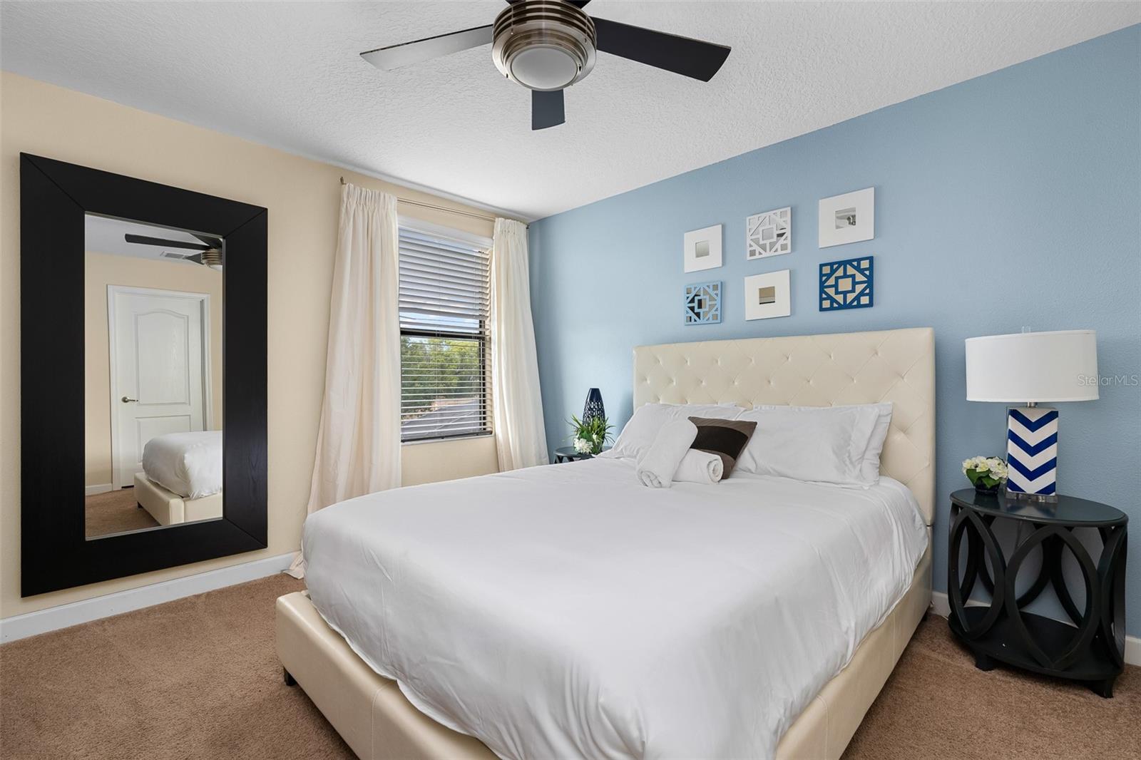 Comfortable Guest Bedroom with Queen Bed and Soft Blue Accents