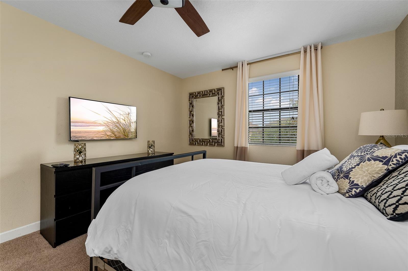 Additional View of the Upstairs Primary Suite with Comfortable Accommodations and Natural Light