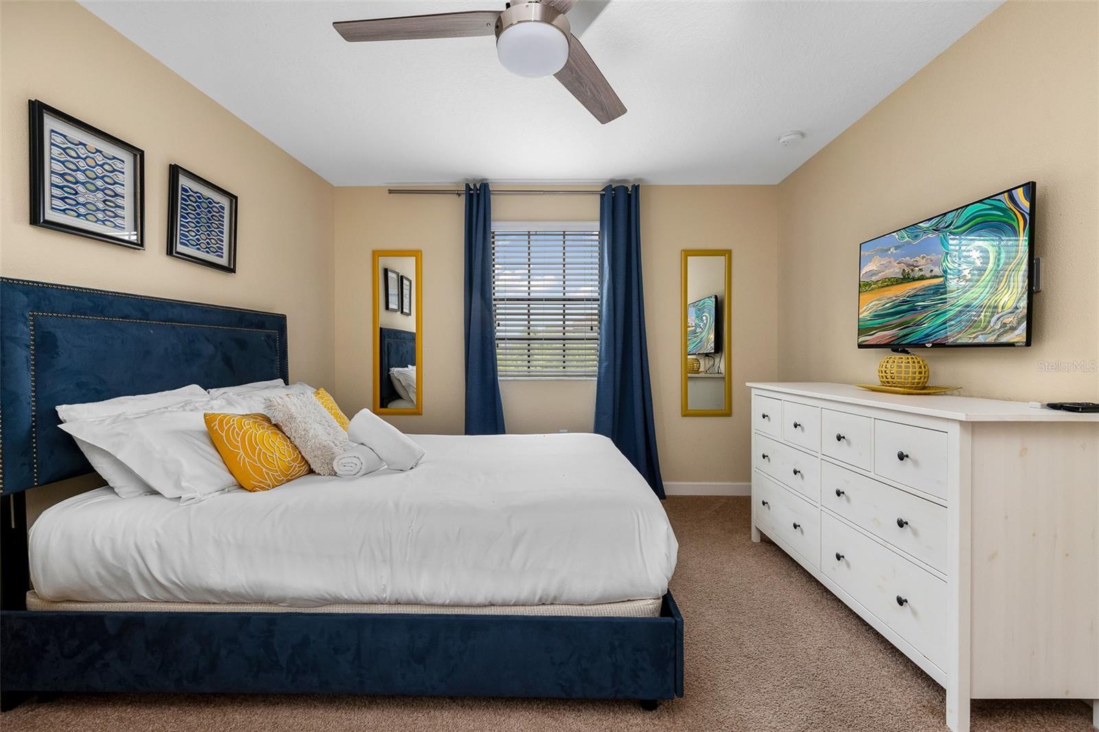 Additional View of the Queen Bedroom with Bright Natural Light and Coordinating Furnishings