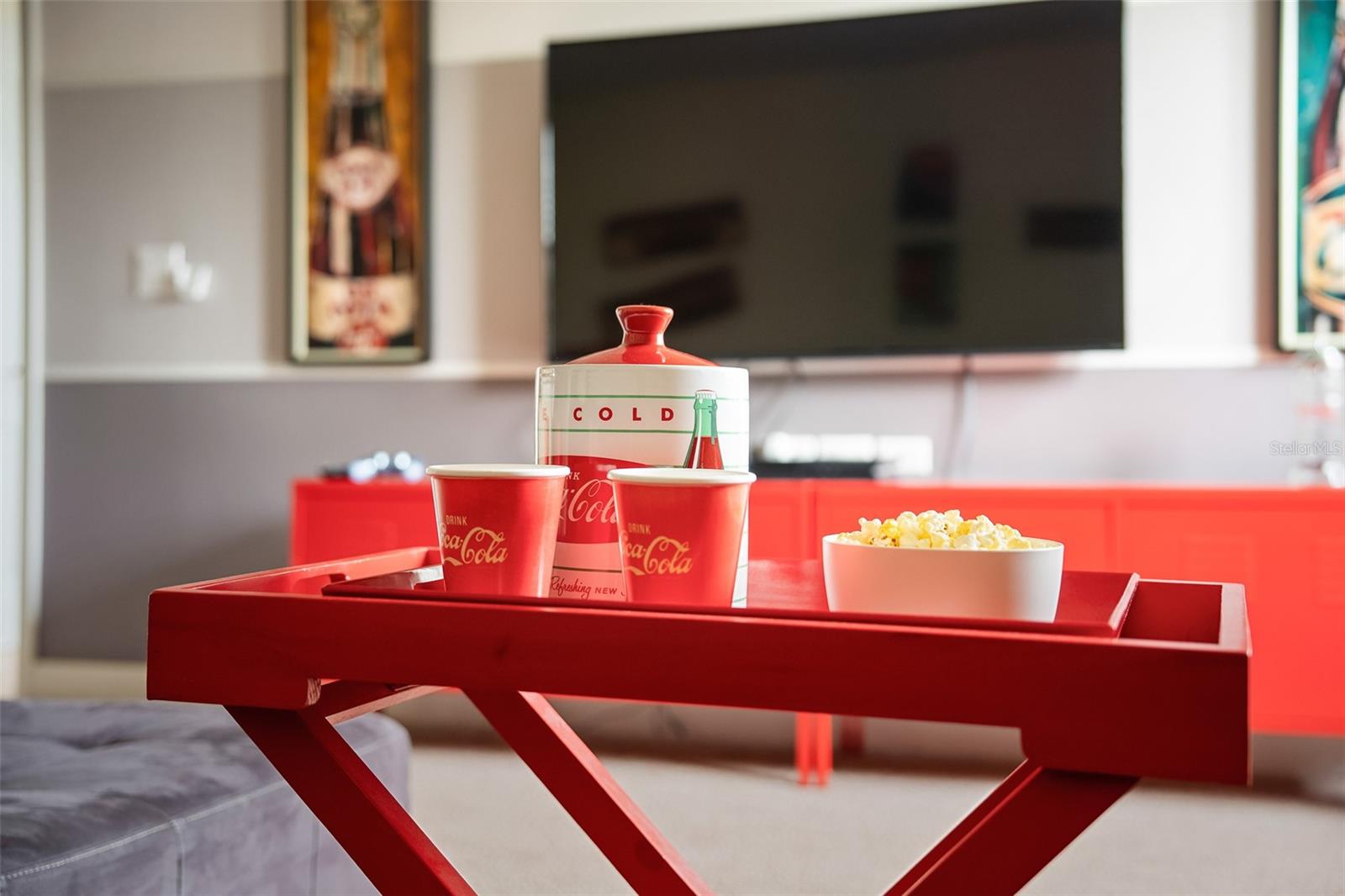 Entertainment Area with Large Flat-Screen TV, Bright Red Cabinetry and Gaming Space