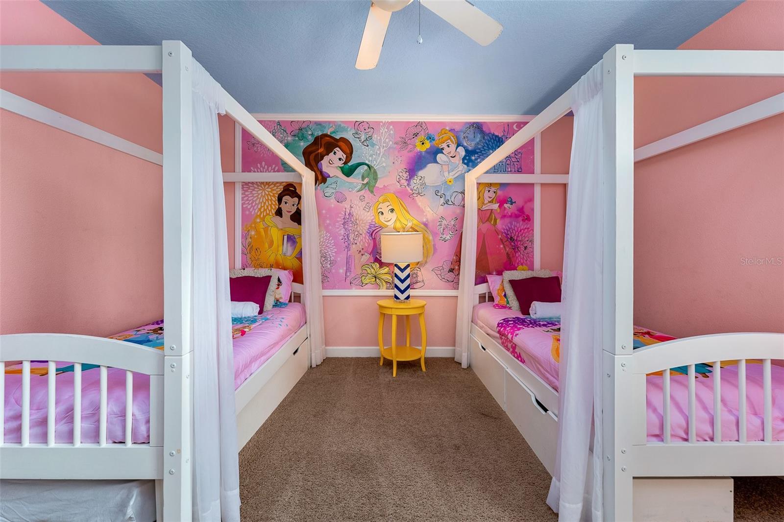 Princess-Themed Retreat with Two Canopy Beds and Colorful Fairytale-Inspired Decor