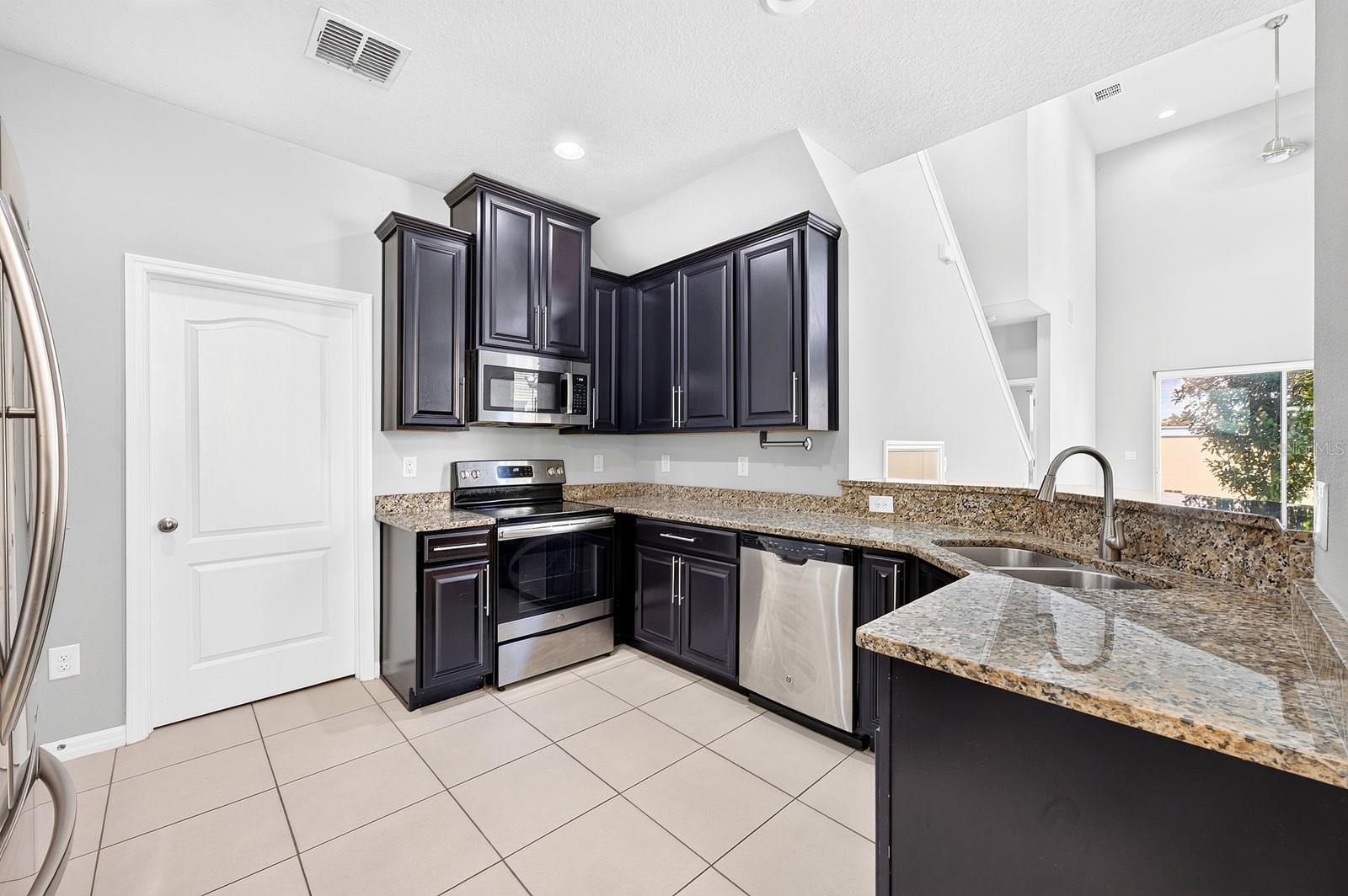 A closet pantry offers convenient storage, while the BREAKFAST BAR provides a natural place for casual meals, conversation or keeping the cook company.