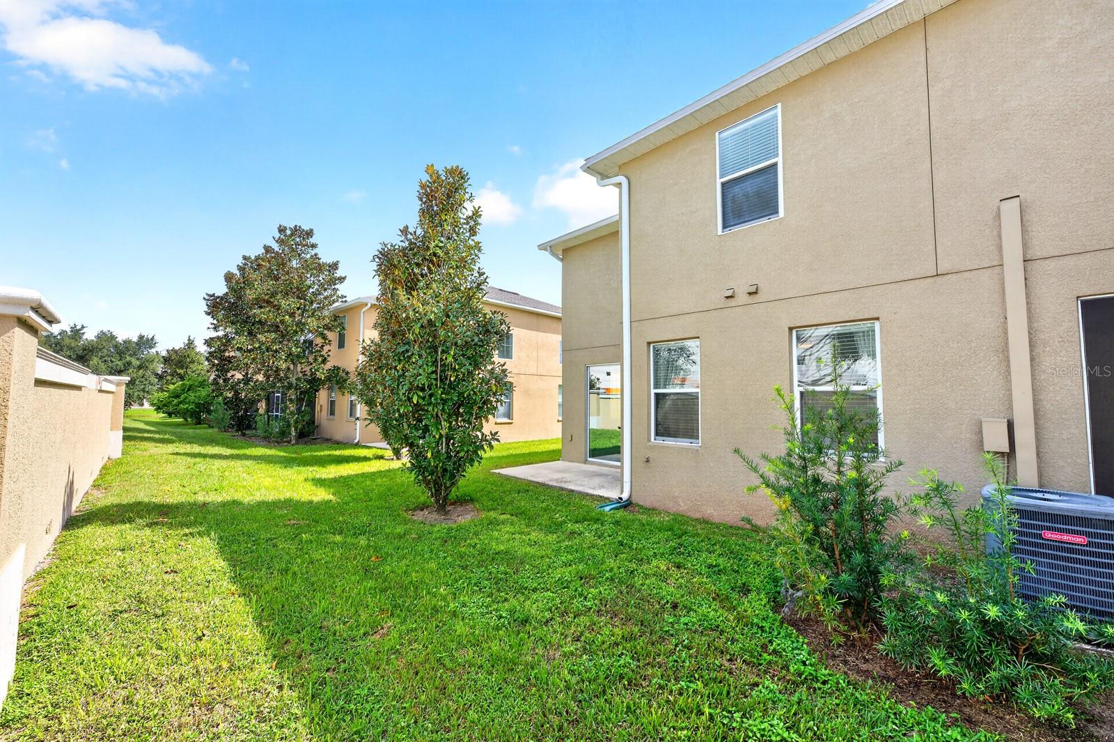 Sliding glass doors extend the living space outdoors to the back patio overlooking a peaceful GREEN SPACEa wonderful spot to enjoy your morning coffee or unwind at the end of the day.