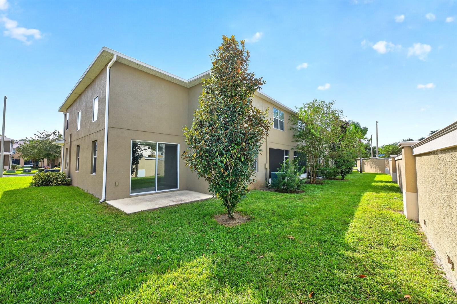 Sliding glass doors extend the living space outdoors to the back patio overlooking a peaceful GREEN SPACEa wonderful spot to enjoy your morning coffee or unwind at the end of the day.
