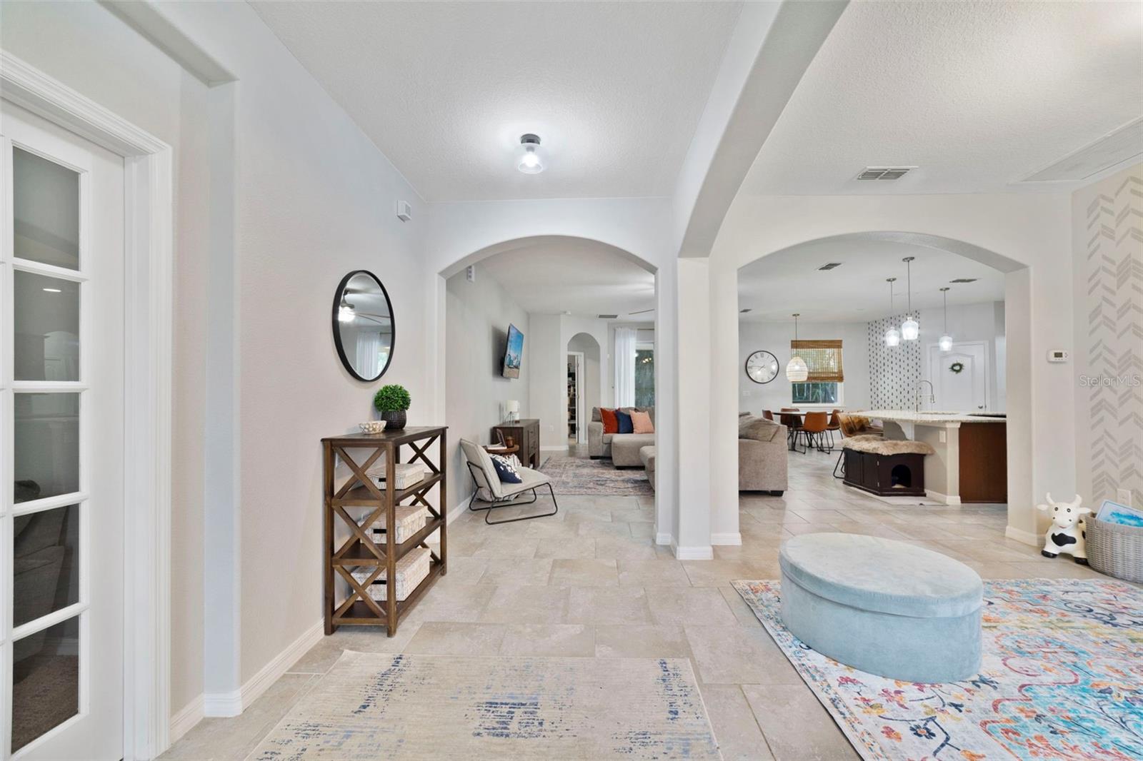 Foyer flows into the open concept living and dining spaces.