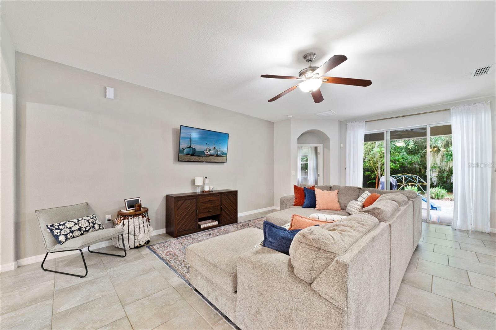 Living area has triple sliding glass doors that open up to the lanai. Living area has triple sliding glass doors that open up to the lanai.