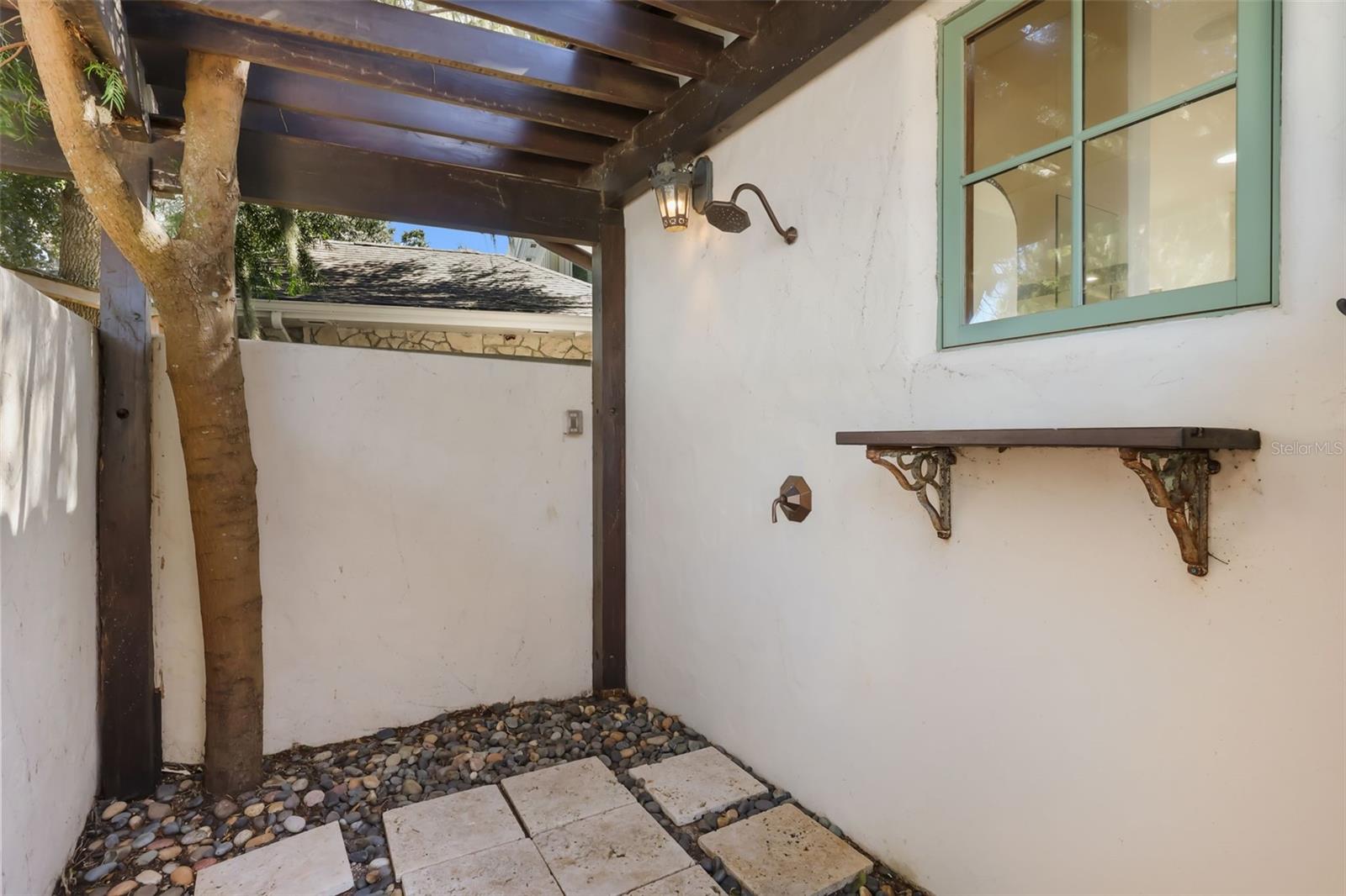 Outdoor shower outside of primary bathroom