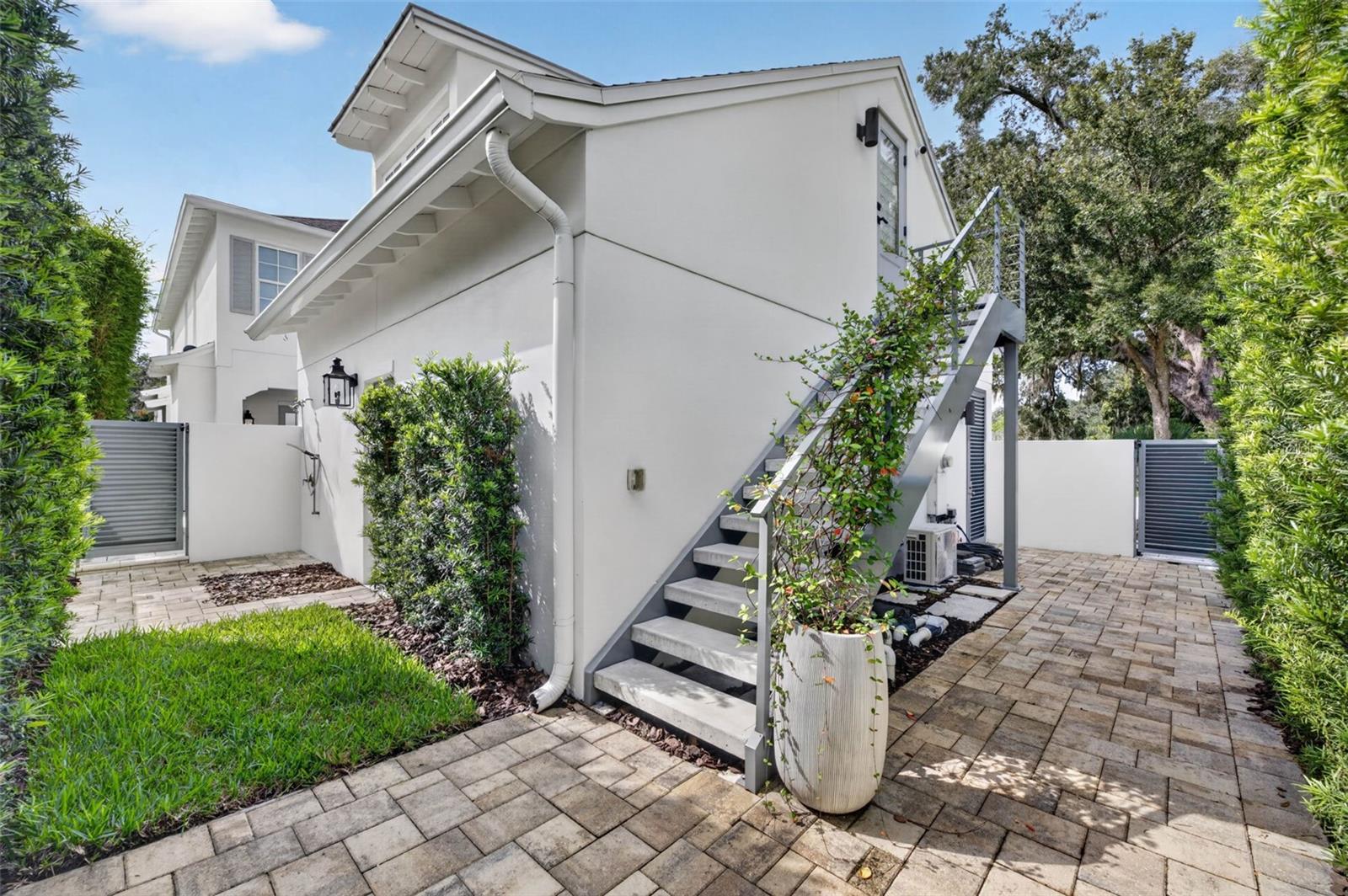 Outdoor shower and upgraded concrete stairs with powder-coated aluminum railings