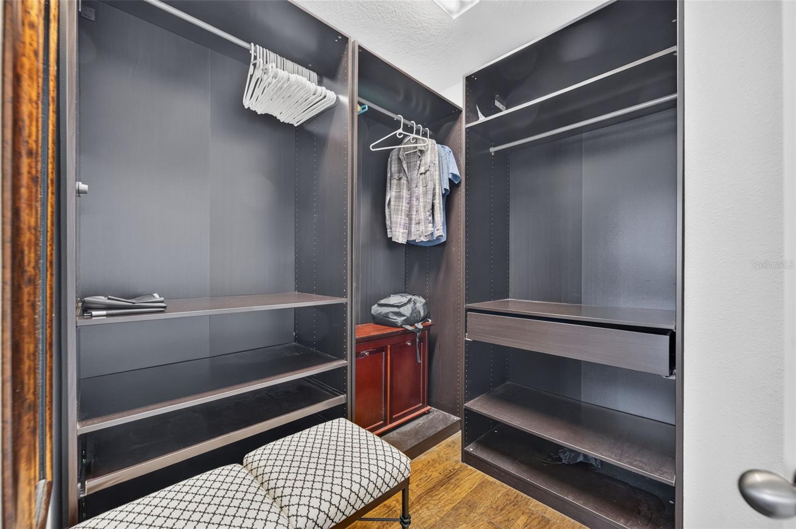 Primary Bedrooms' Walk-in closet with custom cabinetry