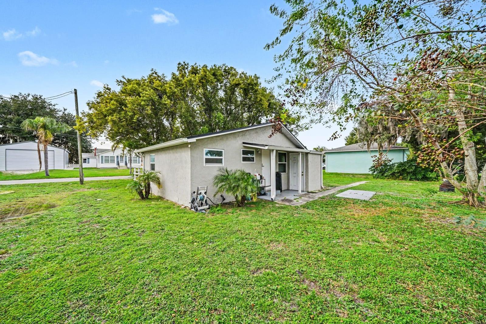 Peaceful setting with updated exterior and spacious lawn surrounded by mature trees