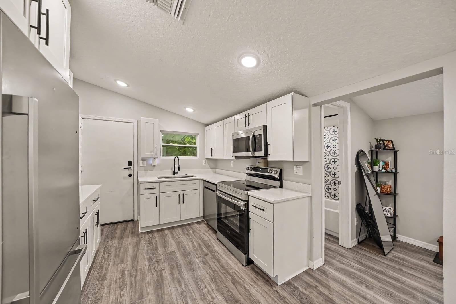 Modern Kitchen Layout with Island Seating and Ample Counter Space
