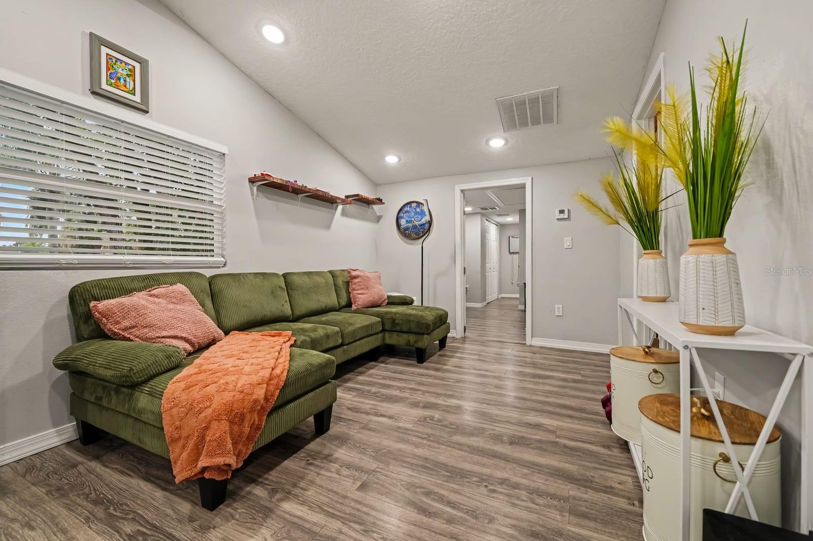 Open living area with sectional seating and abundant natural light