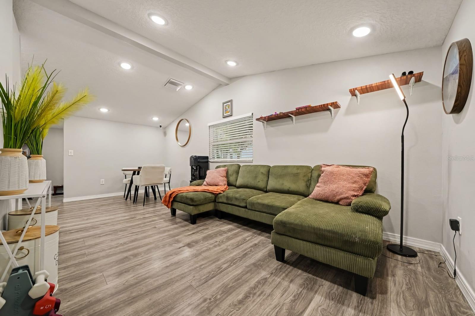 Expansive living space with vaulted ceiling and comfortable seating arrangements