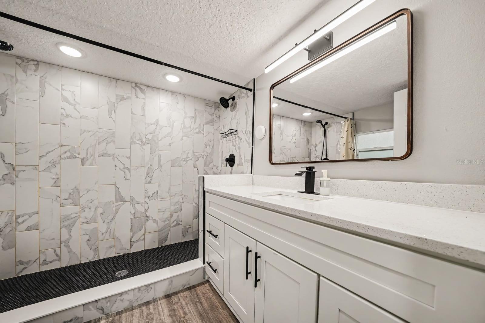 Luxe Primary Bath with Marble Tile Shower and Dual-Sink Vanity