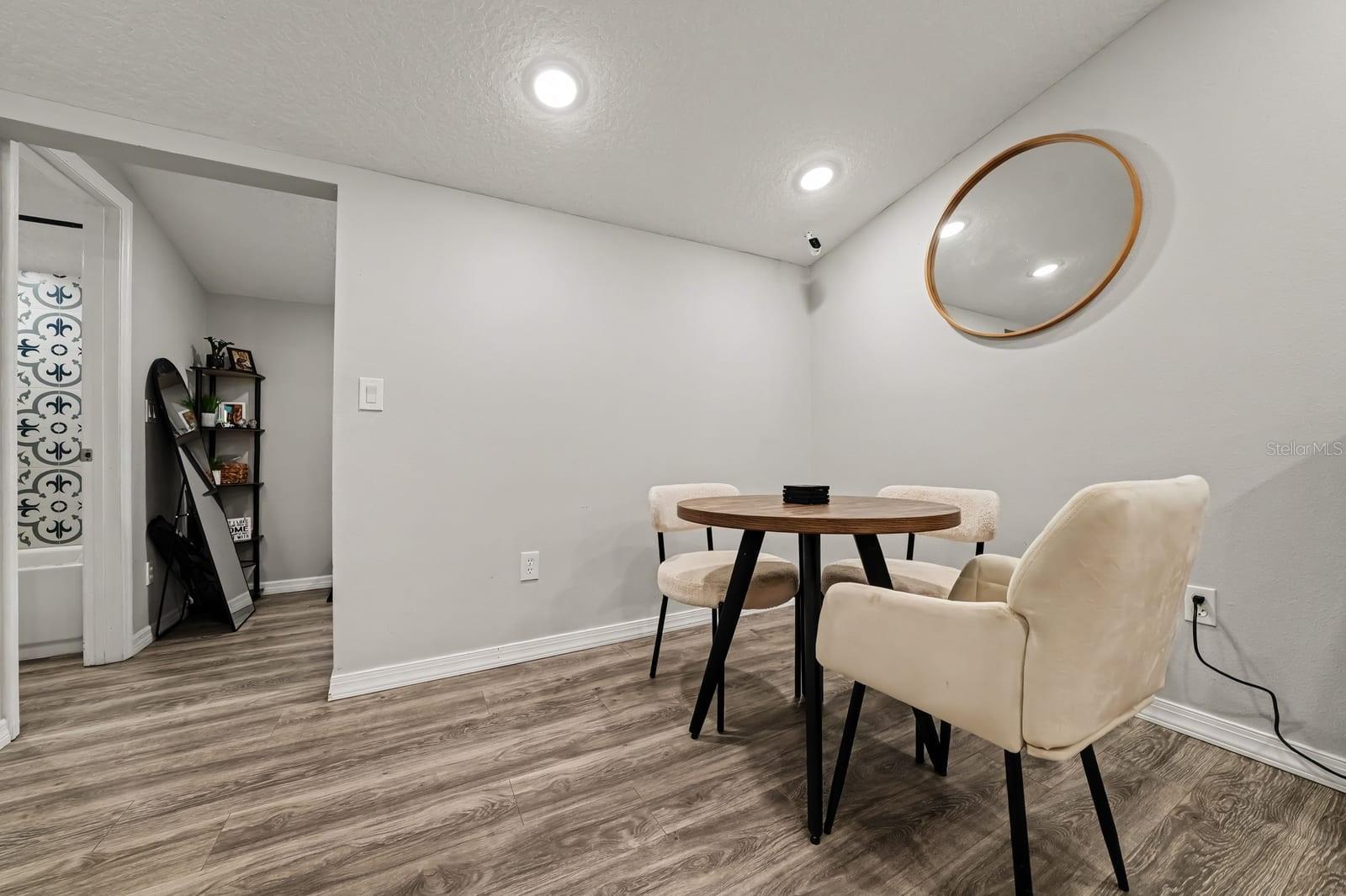 Versatile Dining Space with Mid-Century Table and Accent Wall Mirror