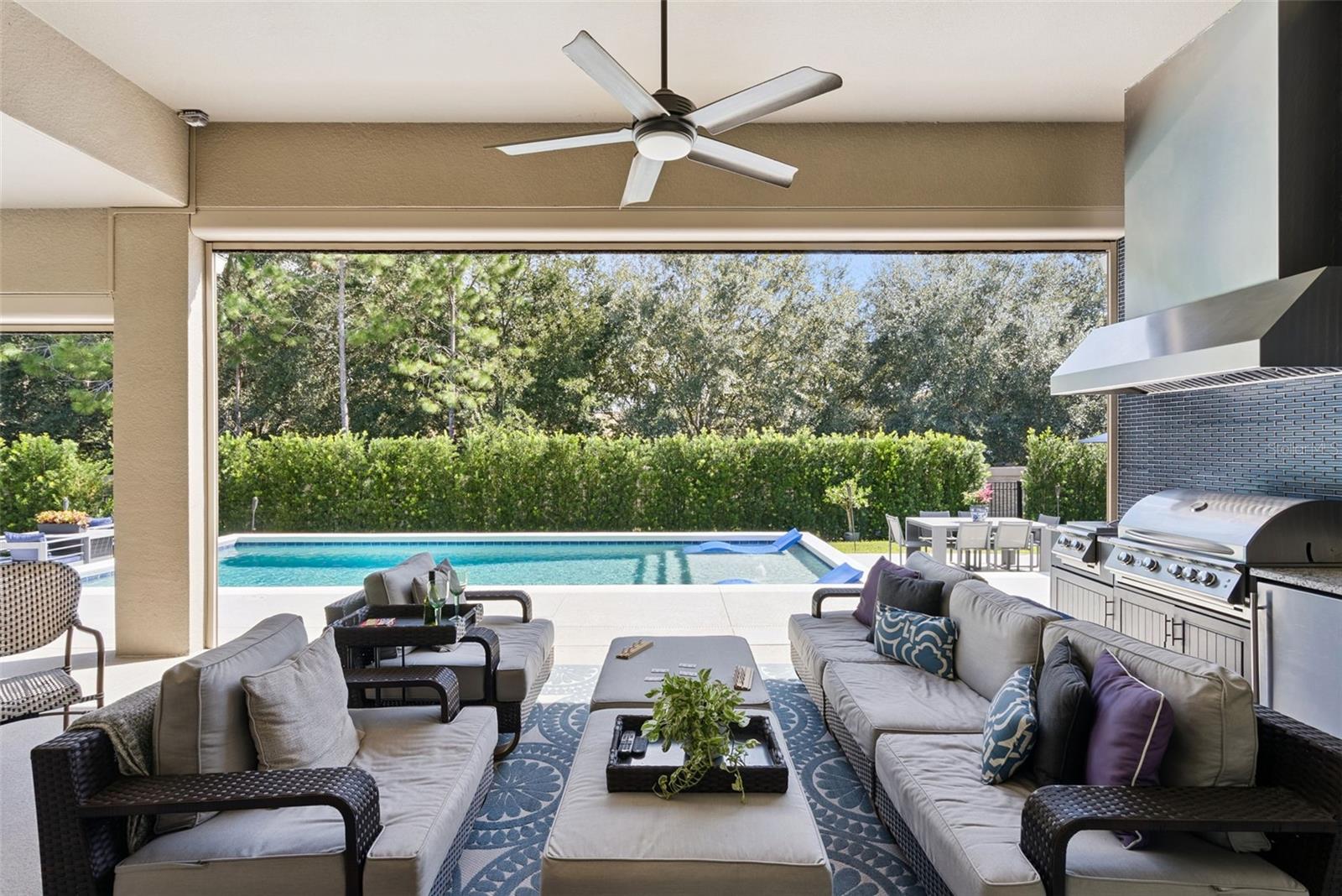Covered lanai and outdoor kitchen w/ remote operated screen enclosure