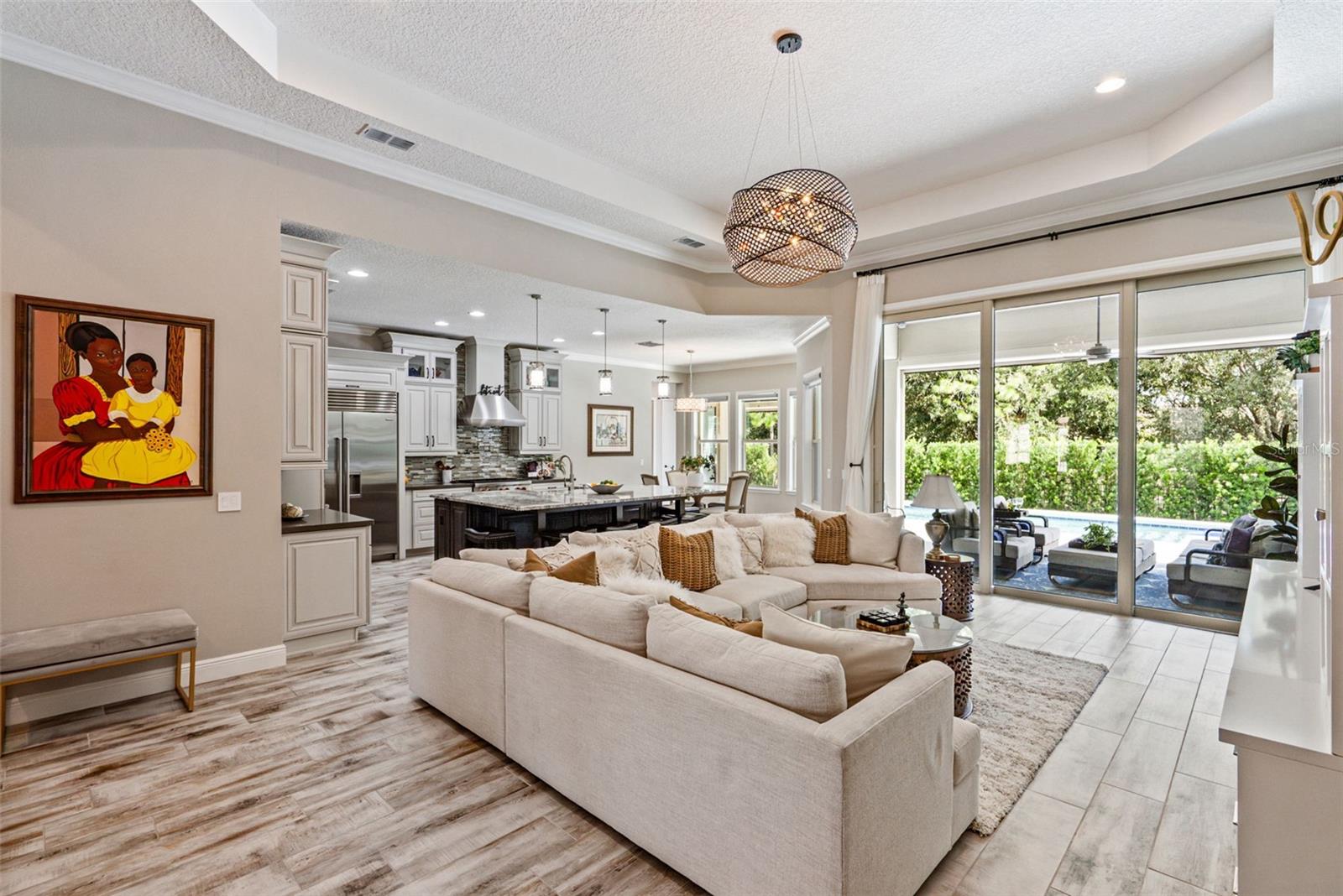 Open layout living room w/ soaring 13-ft ceilings and indoor/outdoor Florida living room