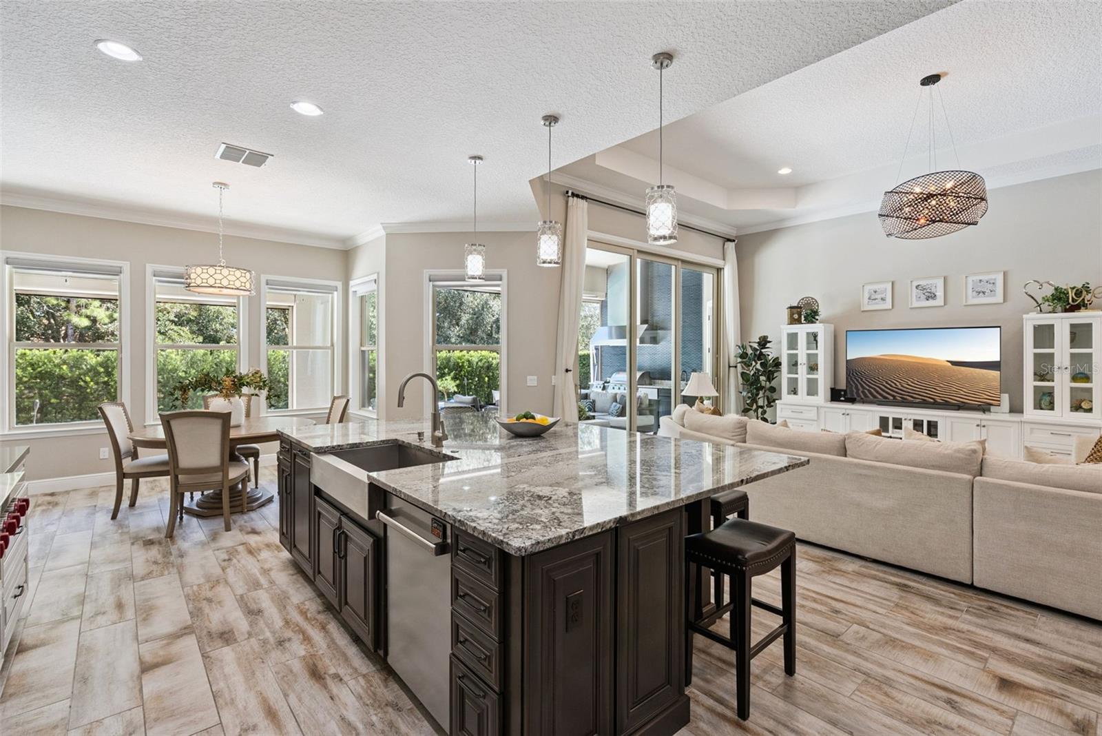 Gourmet kitchen featuring custom cabinetry, Sub-Zero Wolf appliance packages and oversized granite island w/ seating for 6