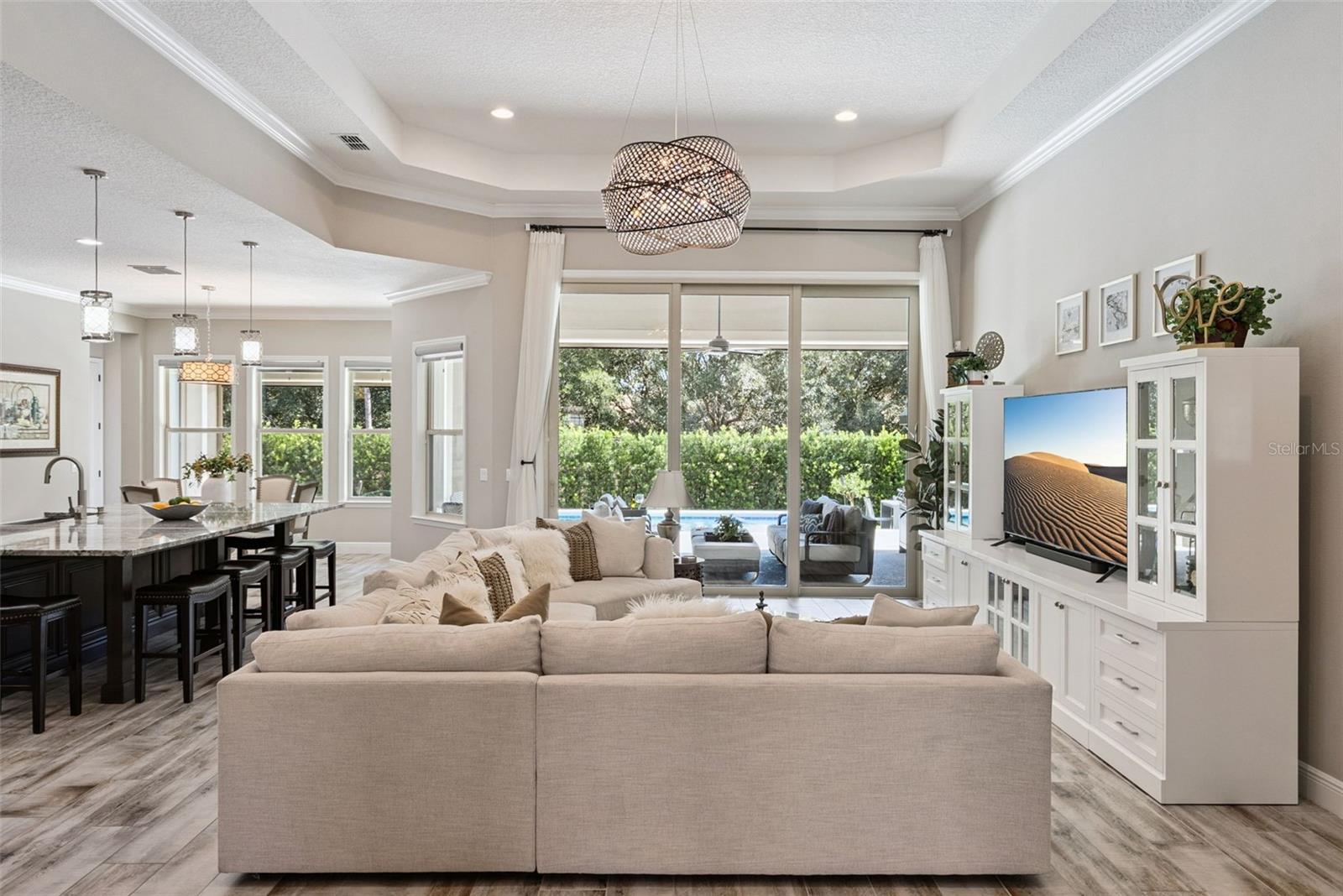 Open layout living room w/ soaring 13-ft ceilings and indoor/outdoor Florida living room