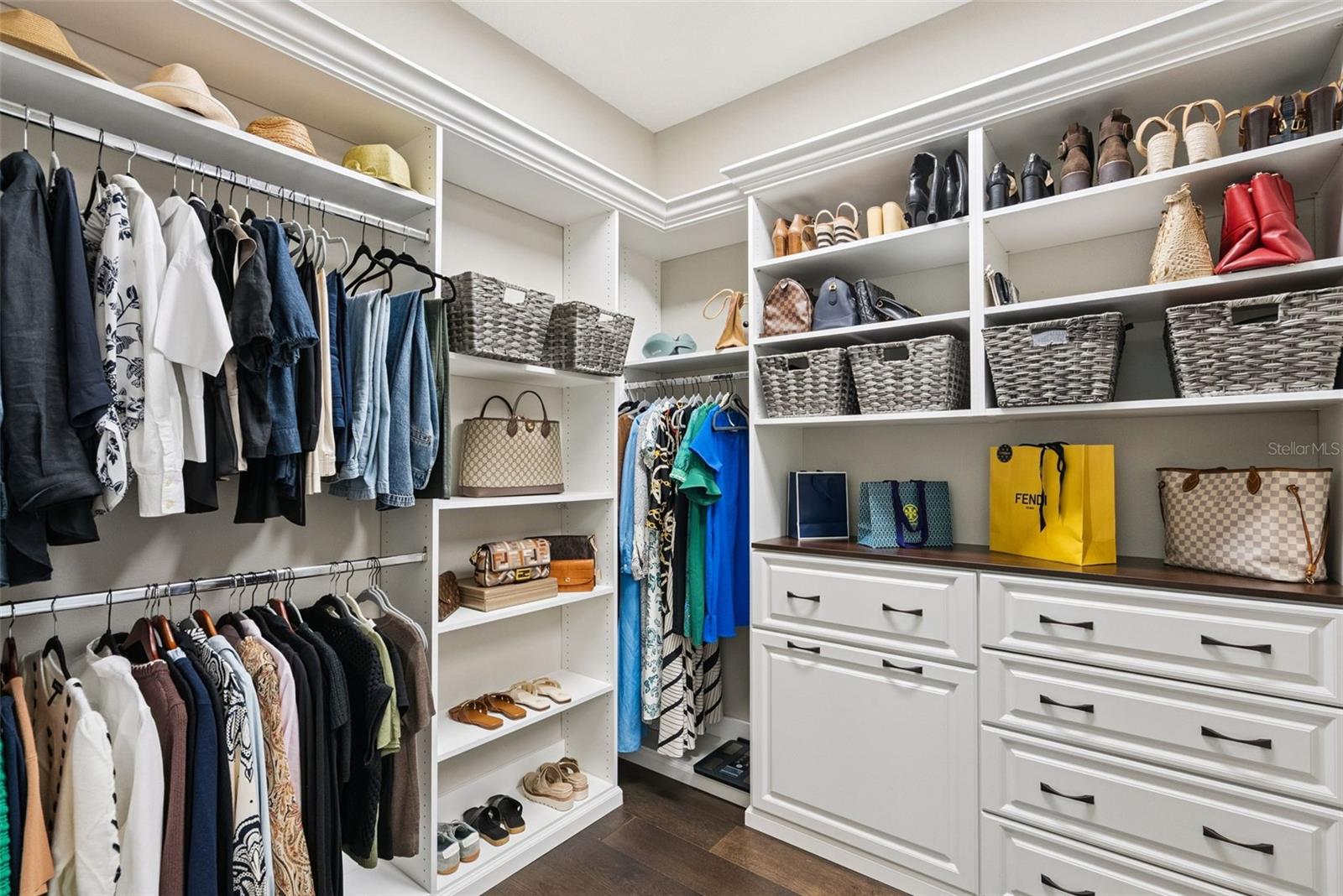 Walk-in owners suite w/ custom closet system by Closets by Design