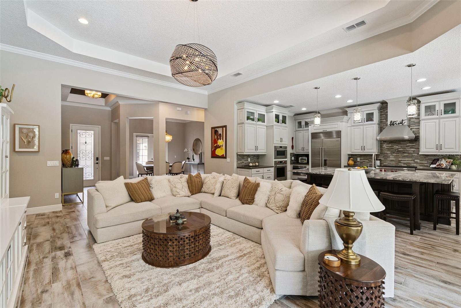 Open layout living room w/ soaring 13-ft ceilings and indoor/outdoor Florida living room