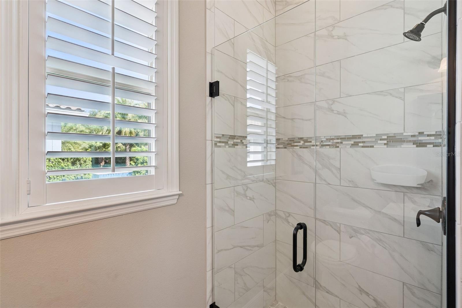 Pool bathroom off kitchen near screened-in, covered lanai
