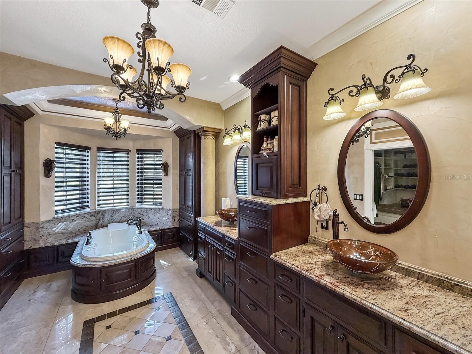Spa bath with double granite vanities and vessel sinks