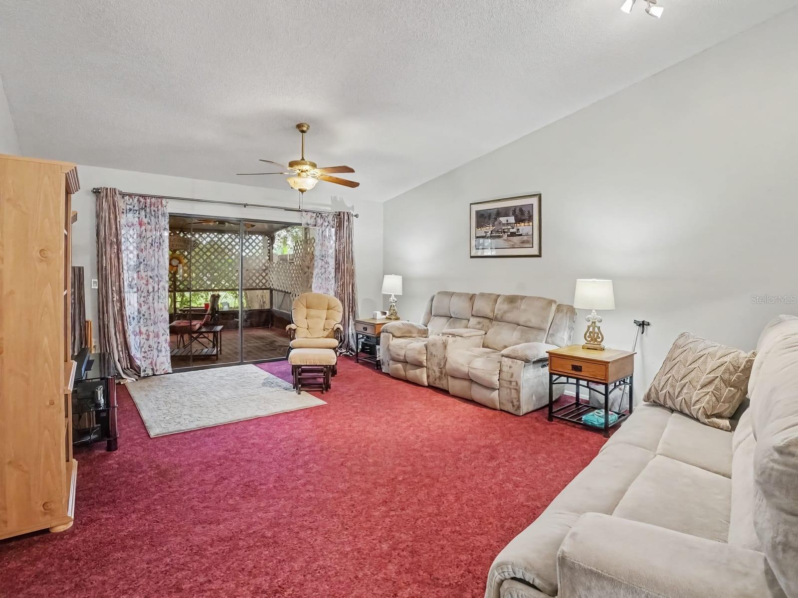 Expansive living room with sliding glass doors to covered patio Expansive living room with sliding glass doors to covered patio