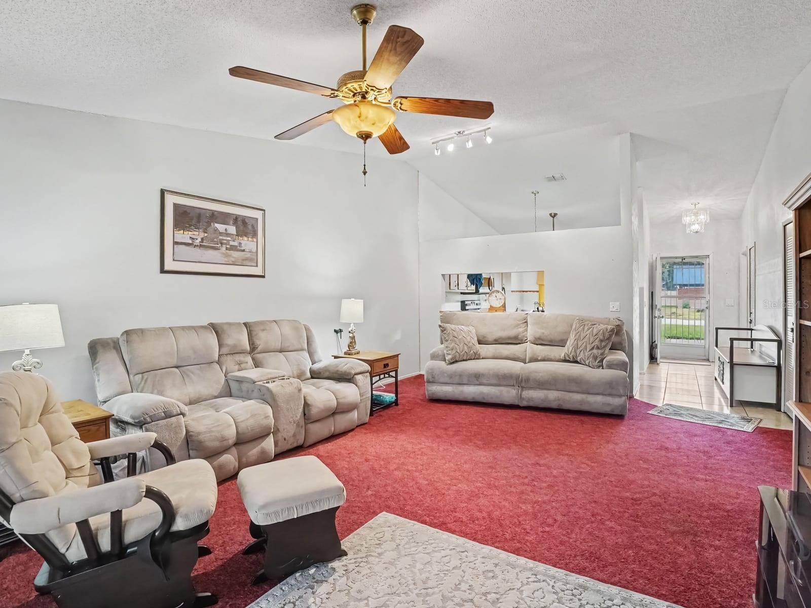 Open-concept living space with multiple seating areas & high ceilings Open-concept living space with multiple seating areas & high ceilings