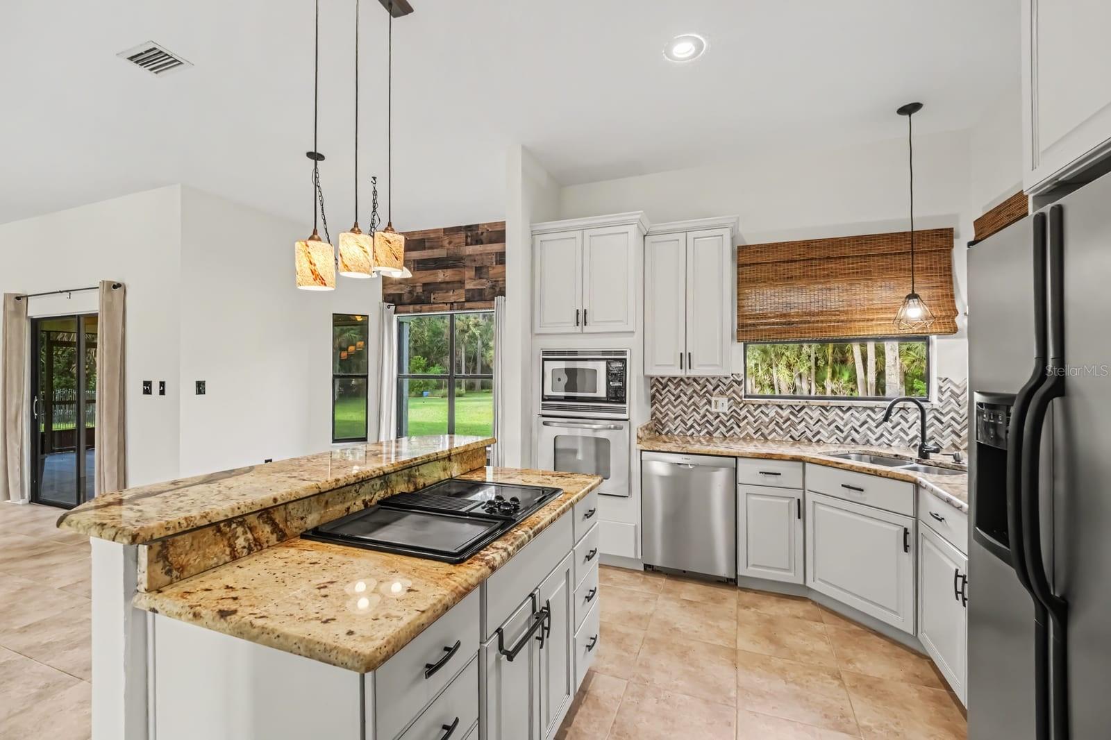Gourmet Kitchen With Dual Islands, Granite Counters & Abundant Natural Light