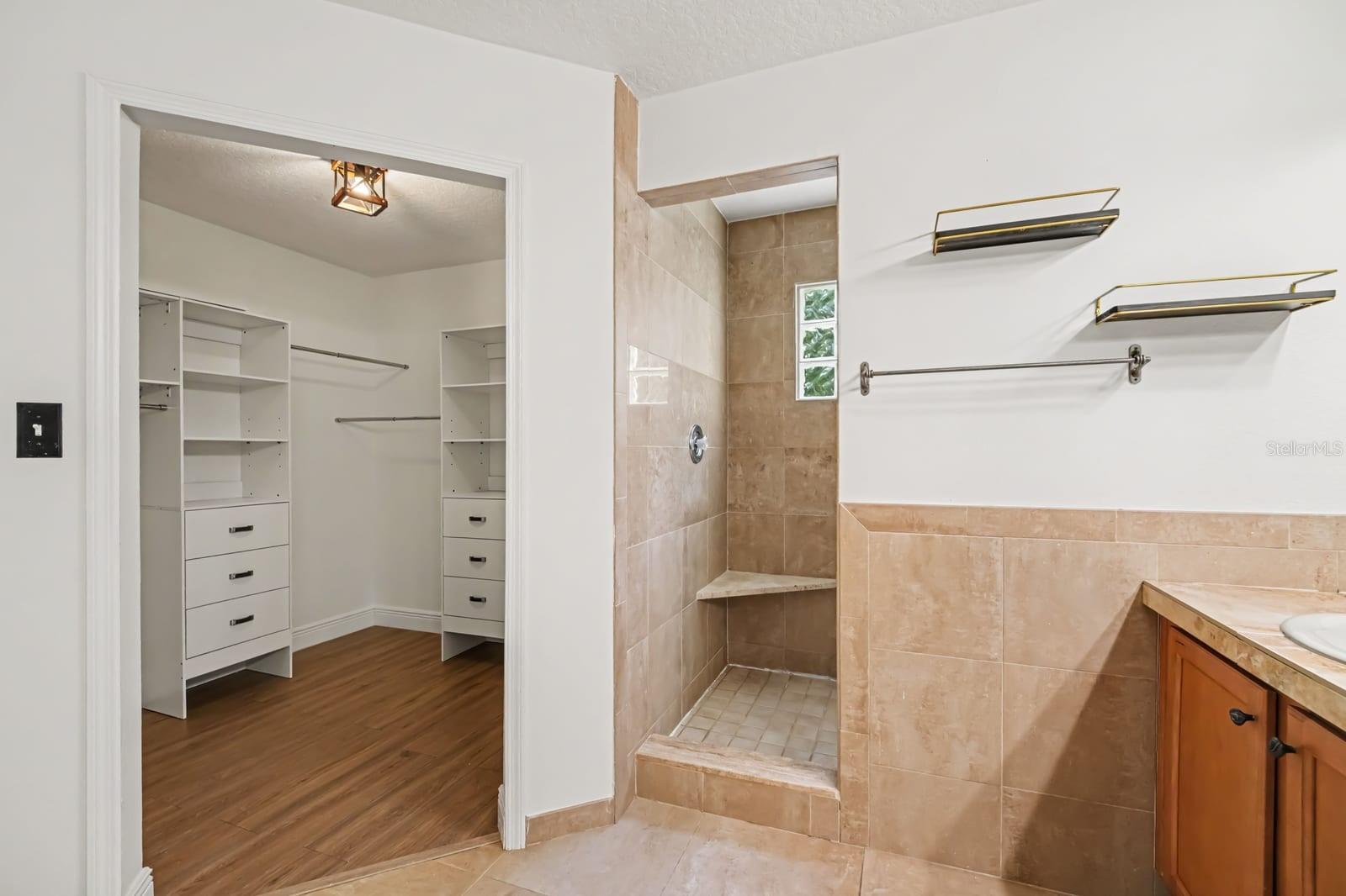 Walk-In Shower with Glass Block Window, Tile Surround, and Built-In Shelf