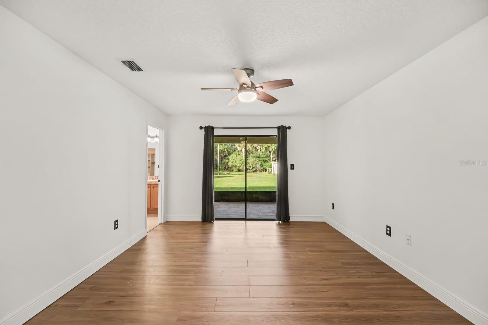 Bright Family Room with Sliding Glass Doors Opening to Backyard and Lawn