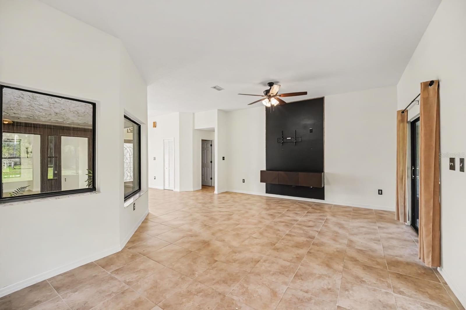 Expansive great room with modern kitchen island and outdoor views
