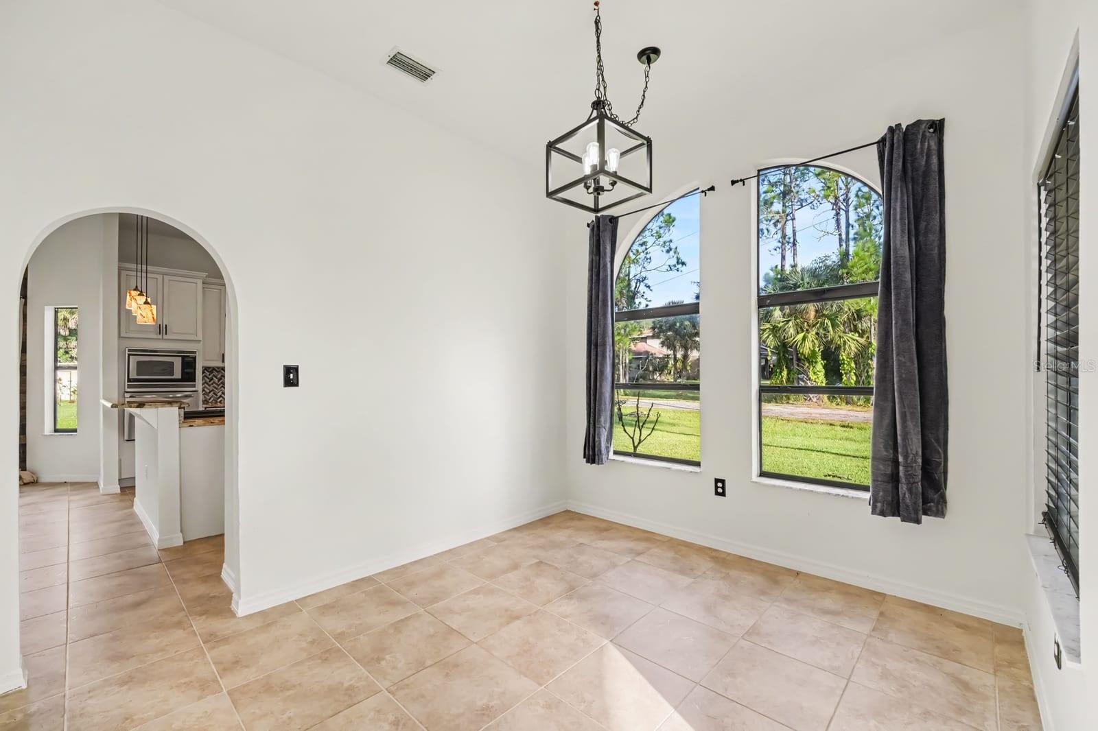 Bright Bedroom With Large Windows, Pendant Lighting & Direct Patio Access