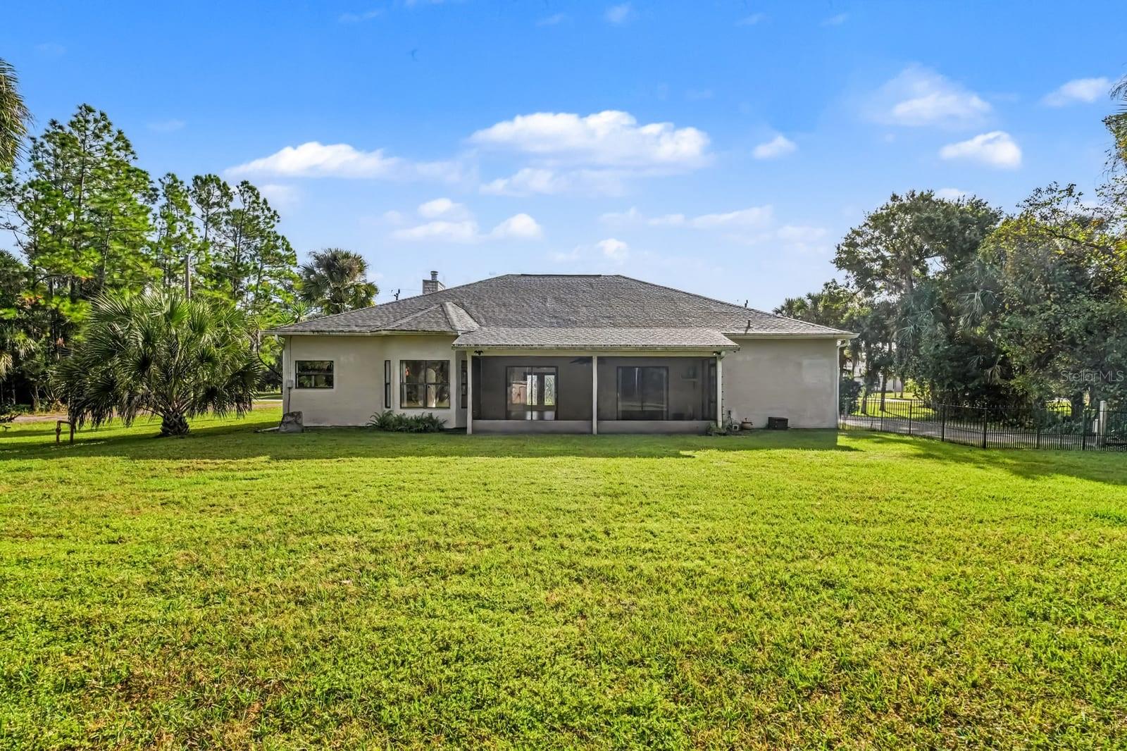 Rear Elevation Showing One-Story Home on Large Manicured Property
